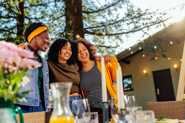 Smiling three women at outdoors gathering