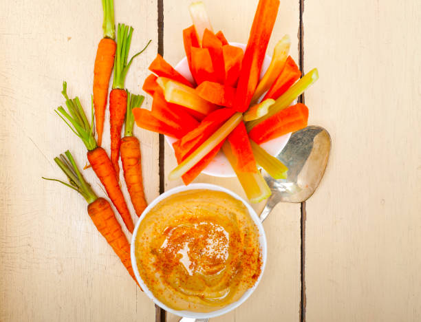 fresh hummus dip with raw carrot and celery