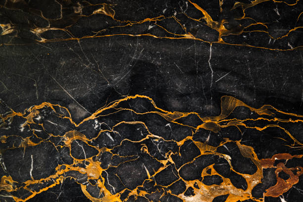 istock Dark marble plate with gold colored veins pattern 1396711673