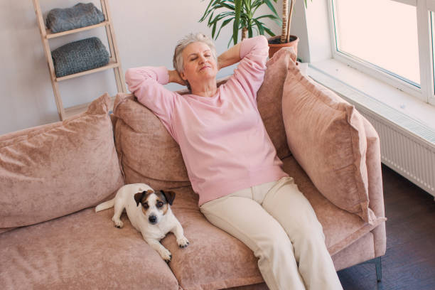 istock Relaxed satisfied older woman sitting leaning back on couch 1396712873