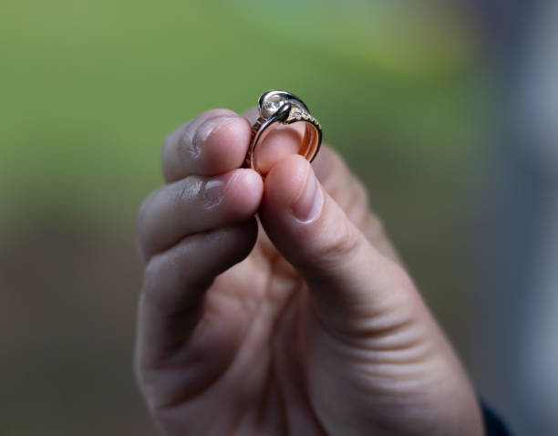 istock Hand Holding Lovely Ring in front of Natural Soft Background 1396713157