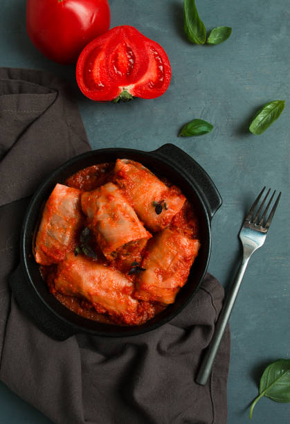 istock Stuffed cabbage rolls in tomato sauce, stuffed cabbage leaves, minced meat with rice, on a dark background, top view, no people, 1396713503