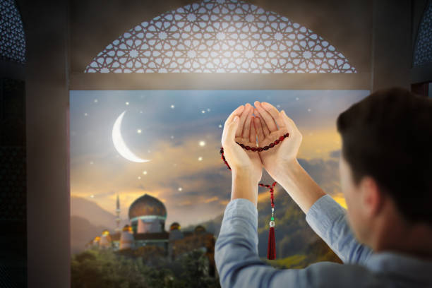 istock Ramadan Kareem greeting. Man praying. 1396714029