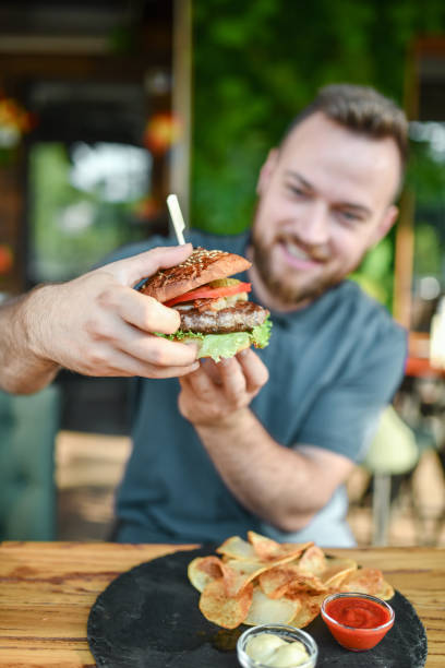 istock Burger Dinner Time For Bearded Smiling Male 1396715454