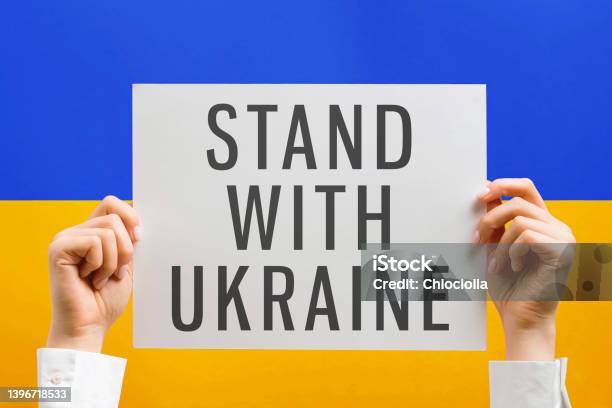 Hands Holding Poster With Text Stand With Ukraine Stock Photo - Download Image Now - Stand with Ukraine, Activist, Blue