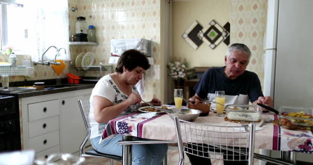 istock Candid husband and wife eating lunch at kitchen 1396718599