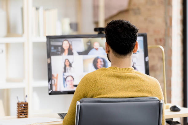 istock Focus on unrecognizable man attending teleconference with co-workers 1396721845