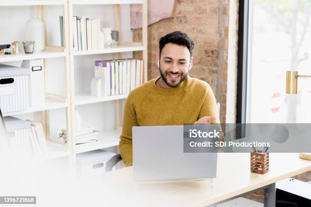 Man Uses Laptop To Video Conference With Friends Stock Photo - Download Image Now - Men, Video Call, Working At Home