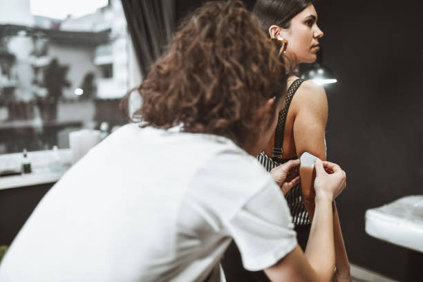 istock Female Getting Stencil Applied By Tattoo Artist 1396722940