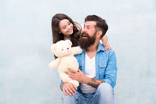 Teddy bear family member. Lovely father and kid. Father and daughter light background. Strengthening father daughter relationships. Child and dad best friends. Family relations. Fathers day concept.