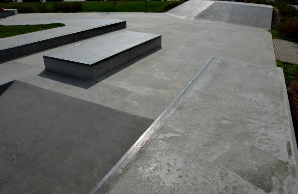 istock Skateboard park with concrete cement surface with concrete skateboard obstacles is designed for roller sports. Cycling is not allowed except for freestyle bikes. icing winter morning sunrise 1396725066
