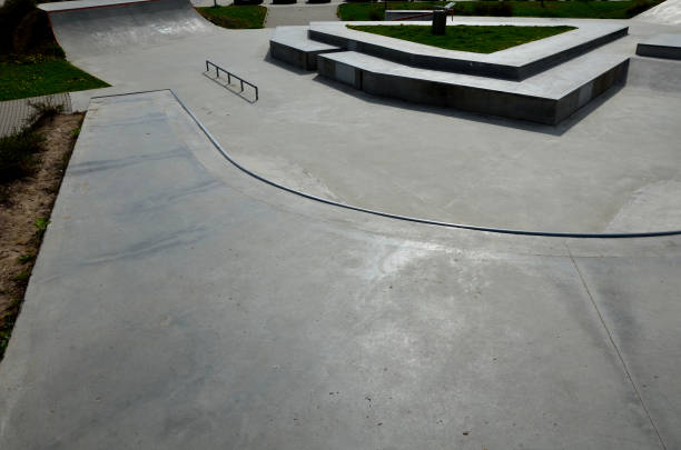 istock Skateboard park with concrete cement surface with concrete skateboard obstacles is designed for roller sports. Cycling is not allowed except for freestyle bikes. icing winter morning sunrise 1396725068