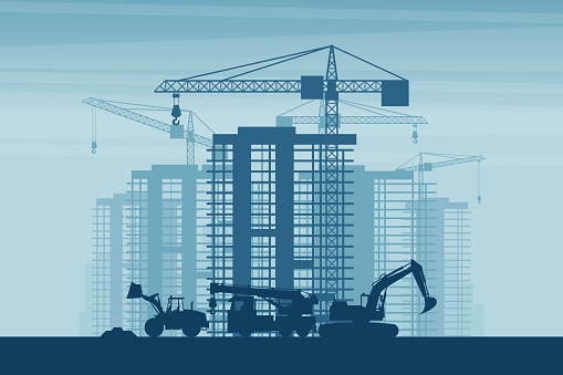 Background of heavy machinery such as front loader, truck crane, excavator, working on the construction of buildings in a city