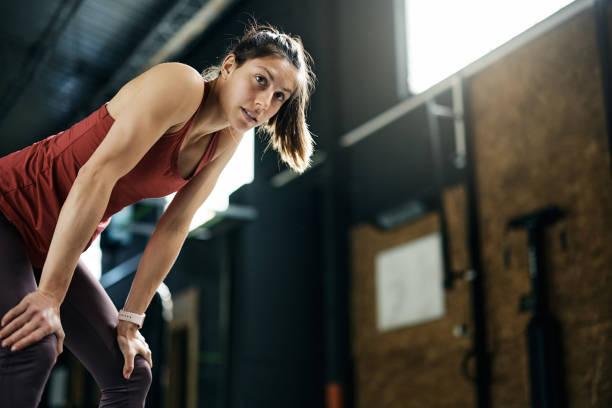istock Below view of athletic woman taking a break during gym workout. 1396728014