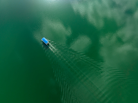Tourboat traveling in the lake. Taken via drone. Antalya, Turkey.