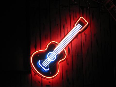 Neon sign on a stage barn.