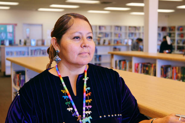 high school teacher in a library - native american north american tribal culture women mature adult imagens e fotografias de stock