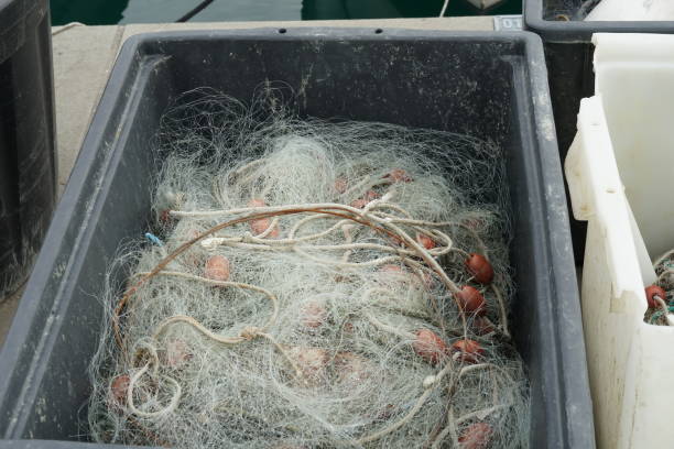 istock Fishing net with white ropes and red-brown floats. 1396730575