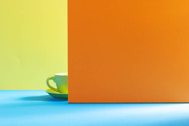 Empty cup of coffee at table. Coffee and colorful background texture. Food and drink minimalism concept style