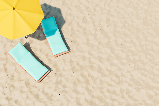3D illustration of comfortable deckchairs with soft pads located near yellow umbrella on sandy beach on resort