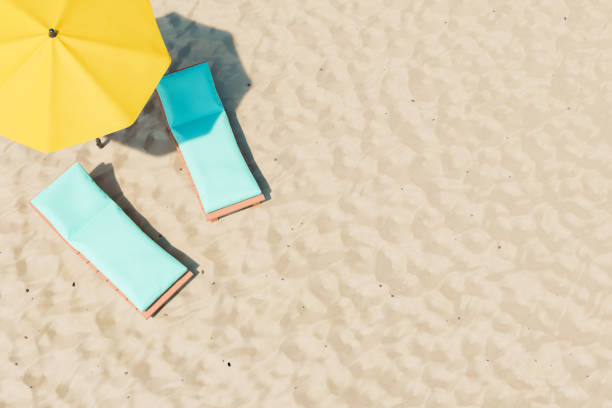 Loungers and parasols on beach 3D illustration of comfortable deckchairs with soft pads located near yellow umbrella on sandy beach on resort beach umbrella photos stock pictures, royalty-free photos & images