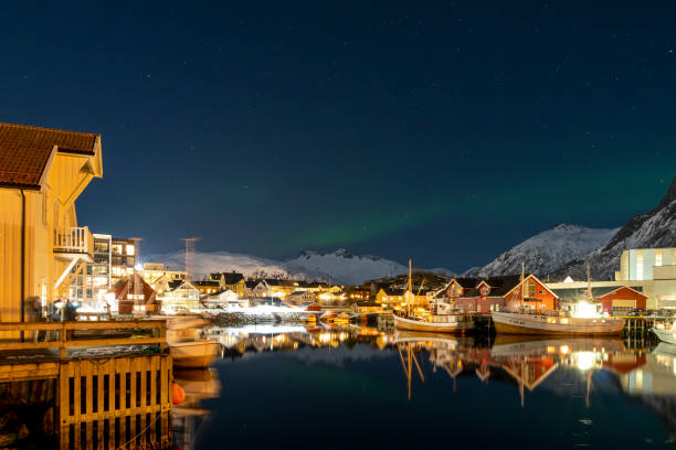 Svolvaer by dusk in Vagan Nordland Lofoten archipelago  North of Norway . Svolvaer with the Northern lights  in Austvagoya island Vagan Nordland Lofoten archipelago  North of Norway on March 12, 2022. View from the island of Lamholmen, in the middle of Svolvær Harbour. harbor of svolvaer in winter lofoten islands norway stock pictures, royalty-free photos & images