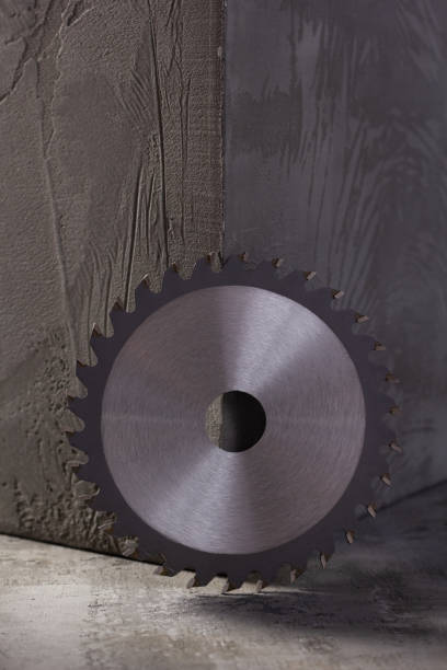 istock Circular blade and concrete wall at abstract cement background texture 1396731044