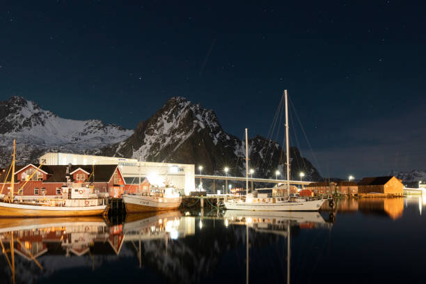 Svolvaer by dusk in Vagan Nordland Lofoten archipelago  North of Norway . Svolvaer with the Northern lights  in Austvagoya island Vagan Nordland Lofoten archipelago  North of Norway on March 12, 2022. View from the island of Lamholmen, in the middle of Svolvær Harbour. harbor of svolvaer in winter lofoten islands norway stock pictures, royalty-free photos & images