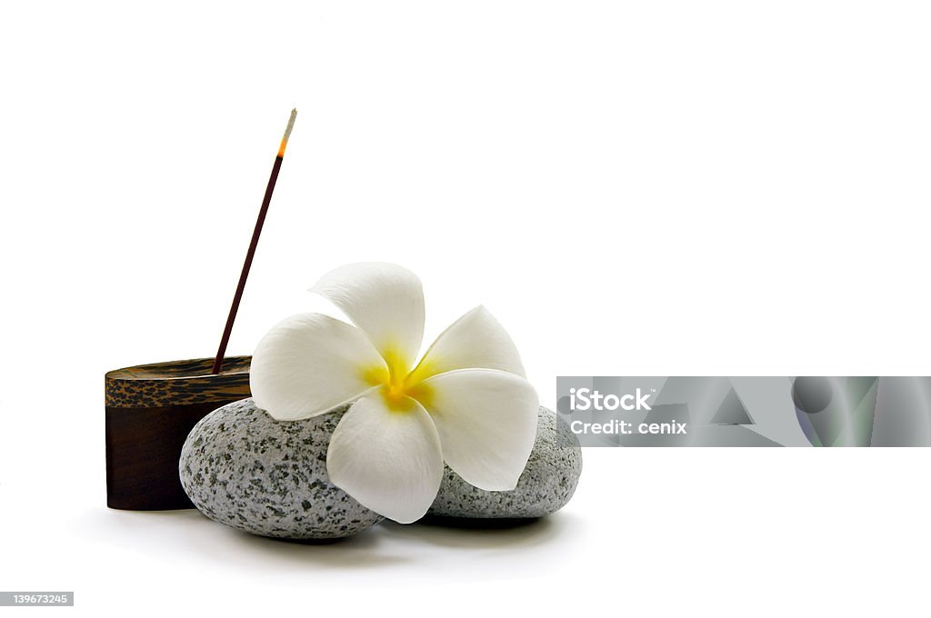 Simple Relaxation A stick of fragrant Japanese incense, some smooth pebbles and a frangipani flower Incense Stock Photo