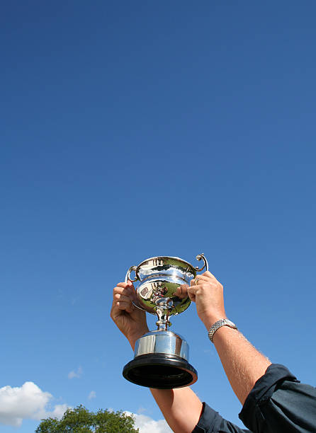 A person holding up a trophy that they won