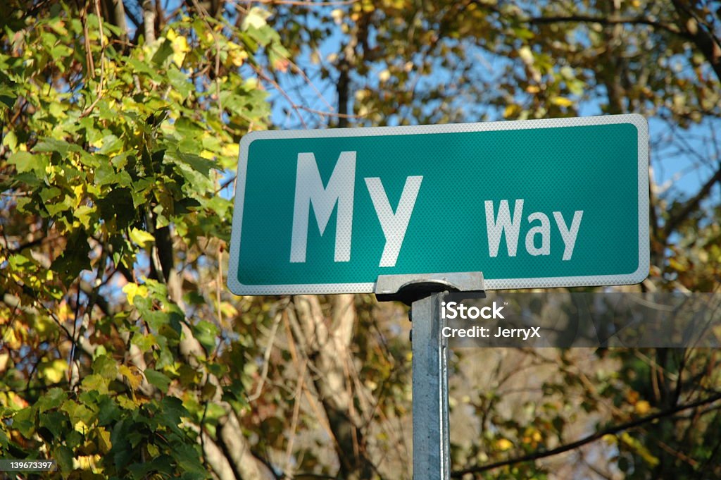 Street sign stating My way with trees in background My Way street sign Strength Stock Photo