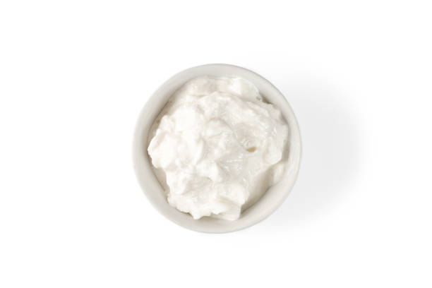 istock Stracciatella cheese. Italian Stretched curd cheese product Stracciatella in bowl isolated on white background. Top view 1396734499