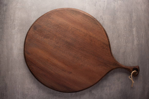istock Cutting board on stone background top table. Wooden pizza board 1396735184