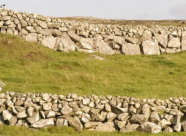 An image of two Stonewalls   one behinf the other - taken in Conamara  Ireland  Summertime