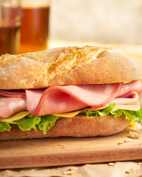 bread sandwich with ham, lettuce and cheese and tomato, front view fresh midday lunch accompanied by draft beer toasted sandwich stock pictures, royalty-free photos & images