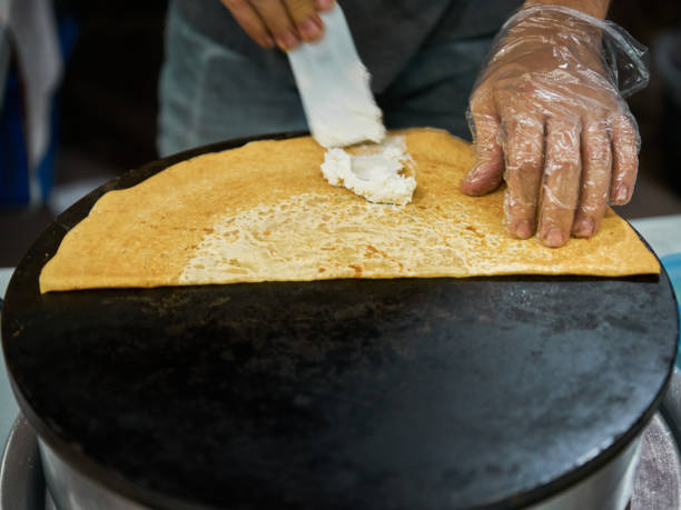 istock Making delicious crepes on a grill with fruit and chocolate 1396736385