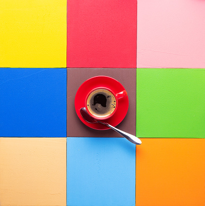 Cup of coffee at colorful abstract background texture. Coffee break time concept