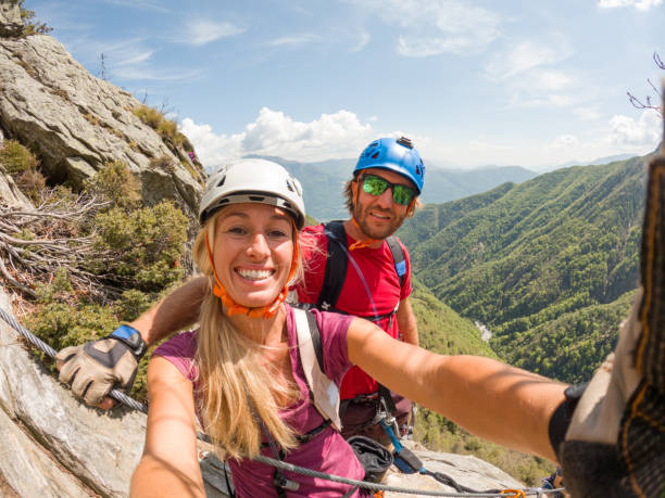 istock Couple taking selfies during a via ferrata climb 1396740641