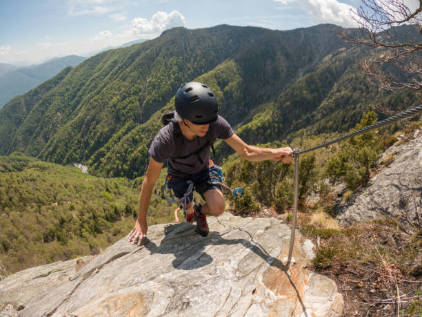 istock Mountaineering man scramble to summit on a via ferrata route 1396740708