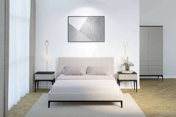 istock Bright bedroom with a horizontal poster above the headboard, sconces and bedside tables with decor on the sides of the bed by the window with curtains, and a wardrobe in the background. 1396740755