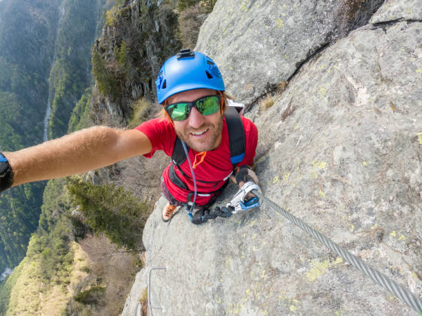 istock Man taking selfie on a Via Ferrata route 1396741043