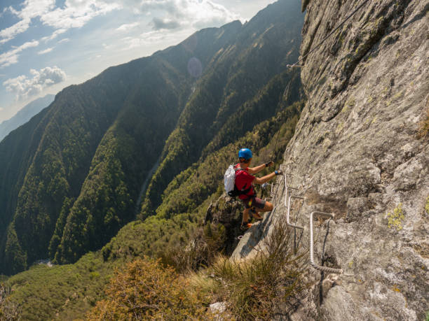 istock Mountaineering man scramble to summit on a via ferrata route 1396741047