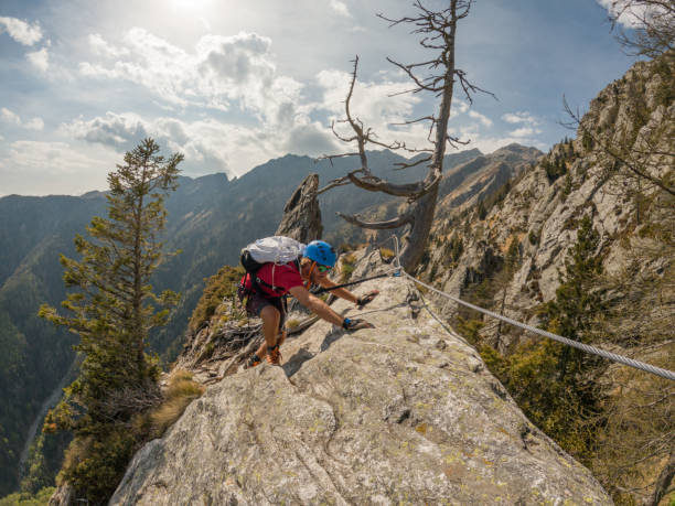 istock Mountaineering man scramble to summit on a via ferrata route 1396741642