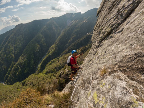 istock Mountaineering man scramble to summit on a via ferrata route 1396741666