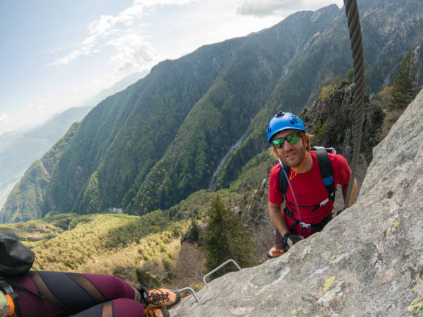 istock Mountaineering man scramble to summit on a via ferrata route 1396741703