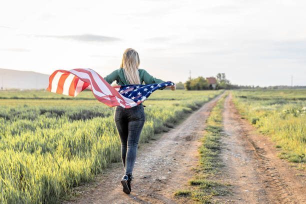 istock Woman flying American Flag 1396741757