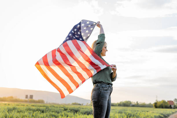 istock Woman holding American flag 1396741866