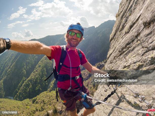Man Taking Selfie On A Via Ferrata Route Stock Photo - Download Image Now - Rock Climbing, Selfie, Climbing