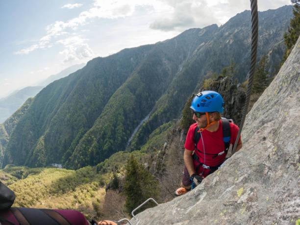 istock Man climbing steep via ferrata on rock cliff 1396741941