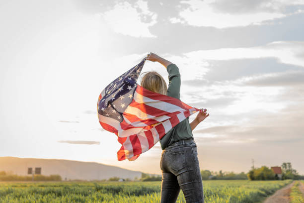 istock Woman holding American flag 1396742619